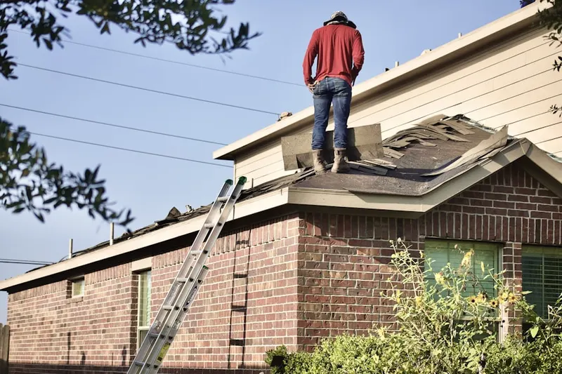 Professional roofer working on a residential roof in Liberty Center